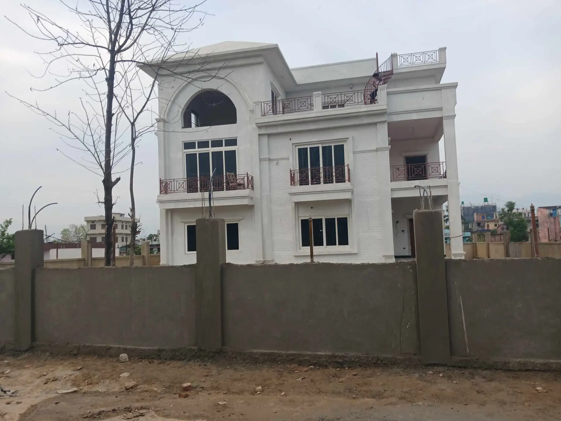 Arched-Window Residence: Completed family house with arched windows, built by HNG in Nepal, image 1 of 3