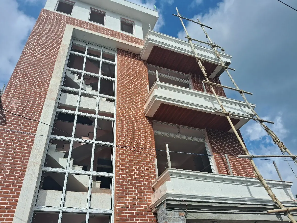Brick & Glass Residence: Brick and glass residential building under construction by HNG, image 2 of 2